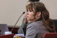 Hannah Gutierrez-Reed, the former armorer on the set of the movie "Rust," listens to Corporal Alexandra Hancock, with the Santa Fe Sheriff's Office, testify during Gutierrez-Reed's trial at district court in Santa Fe, N.M., on Wednesday, Feb. 28, 2024. (Luis Sánchez Saturno/Santa Fe New Mexican via AP, Pool)