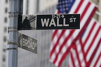 A street sign is seen in front of the New York Stock Exchange in New York, Tuesday, June 14, 2022.