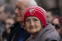 A woman wears a Red Star soccer club cap attends a rally of ProGlas initiative in Nis, Serbia, Sunday, Dec. 10, 2023. ProGlas initiative was formed by a number of prominent public figures to call the electorate to turn out to vote at the Dec. 17 elections. Serbia's President Aleksandar Vucic is pushing hard to reassert his populist party's dominance at this weekend's early parliamentary and local elections that observers say are being held in an atmosphere of intimidation and media bias. (AP Photo/Darko Vojinovic)