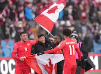 Canada players (left to right) Lucas Cavallini, Jonathan Osorio, Richie Laryea and Tajon Buchanan celebrate their 4-0 win over Jamaica during second half CONCACAF World Cup soccer qualifying action in Toronto on Sunday, March 27, 2022. THE CANADIAN PRESS/Nathan Denette