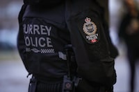 A Surrey police department logo is seen on an officer's jacket in Surrey, B.C., Monday, Oct. 31, 2022. B.C. Supreme Court Justice Kevin Loo says court documents detailing alleged bullying and harassment of Surrey Police Service members by the RCMP shouldn't be kept from the public. THE CANADIAN PRESS/Darryl Dyck