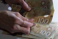 Canadian $100 bills are counted in Toronto, Feb. 2, 2016. The Financial Services Regulatory Authority of Ontario says anyone using the financial planner or advisor title will soon be overseen by a credentialing body and subject to a complaints and discipline process.&nbsp;THE CANADIAN PRESS/Graeme Roy