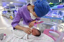 A nurse takes care of a newborn baby at a hospital in Fuyang, in China's eastern Anhui province on January 17, 2023. (Photo by AFP) / China OUT (Photo by STR/AFP via Getty Images)