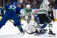 Vancouver Canucks goaltender Thatcher Demko (35) stops Dallas Stars' Wyatt Johnston (53) as Vancouver’s Tyler Myers (57) watches during the first period of an NHL hockey game in Vancouver. on Saturday, Nov. 4, 2023. THE CANADIAN PRESS/Ethan Cairns 