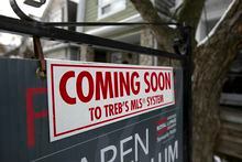 A Coming Soon sign is hung over a For Sale sign posted outside a home in the East end of Toronto near Woodbine and Danforth Avenue on January 23, 2020. (Photo by Deborah Baic)