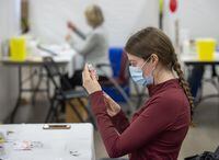 Health care workers prepare injections at a COVID-19 vaccination clinic in Halifax on Friday, April 16, 2021. THE CANADIAN PRESS/Andrew Vaughan