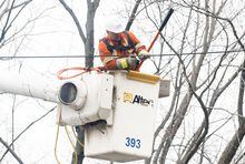 A Hydro-Québec crew member works on restoring power following an ice storm, in the Montreal suburb of Beaconsfield, Que., Tuesday, April 11, 2023. THE CANADIAN PRESS/Graham Hughes