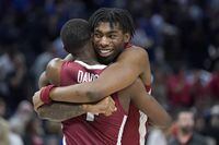Arkansas guard Davonte Davis, left, celebrates with forward Kamani Johnson after Arkansas defeated Gonzaga in a college basketball game in the Sweet 16 round of the NCAA tournament in San Francisco, Thursday, March 24, 2022. (AP Photo/Marcio Jose Sanchez)