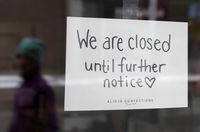 A sign on a shop window indicates the store is closed in Ottawa, Monday March 23, 2020. Ontario Premier Doug Ford announced non-essential businesses would be ordered closed. THE CANADIAN PRESS/Adrian Wyld