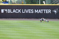 BUFFALO, NEW YORK - AUGUST 11: Francisco Cervelli #29 of the Miami Marlins stretches in front of a Black Lives Matter sign before an MLB game against the Toronto Blue Jays at Sahlen Field on August 11, 2020 in Buffalo, New York. The Blue Jays are the home team due to their stadium situation and the Canadian governments policy on the coronavirus (COVID-19). (Photo by Bryan M. Bennett/Getty Images)