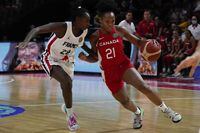 Canada's Nirra Fields, right, runs past France's Mamignan Toure during their game at the women's Basketball World Cup in Sydney, Australia, Friday, Sept. 23, 2022. (AP Photo/Mark Baker)