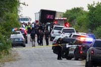 Law enforcement officers work at the scene where people were found dead inside a trailer truck in San Antonio, Texas, U.S. June 27, 2022. REUTERS/Kaylee Greenlee Beal