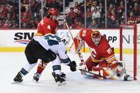 Mar 22, 2022; Calgary, Alberta, CAN; San Jose Sharks forward Scott Reedy (54) is stopped by Calgary Flames goalie Jacob Markstrom (25) during the second period at Scotiabank Saddledome. Mandatory Credit: Candice Ward-USA TODAY Sports