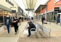 People shop at the Toronto Premium Outlets mall on Black Friday for shopping sales during the COVID-19 pandemic in Milton, Ont., Friday, Nov. 27, 2020. Halton and York region is still open for in person shopping as Toronto and Peel are in lockdown. THE CANADIAN PRESS/Nathan Denette