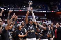 Las Vegas Aces' A'ja Wilson holds up the championship trophy as she celebrates with her team their win in the WNBA basketball finals against the Connecticut Sun, Sunday, Sept. 18, 2022, in Uncasville, Conn. (AP Photo/Jessica Hill)