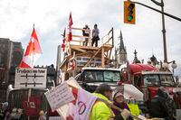 Protestors gather along Wellington Street as a protest against COVID-19 restrictions that has been marked by gridlock and the sound of truck horns reaches its 14th day, in Ottawa, Thursday, Feb. 10, 2022. THE CANADIAN PRESS/Nick Iwanyshyn