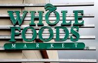 In this Aug. 28, 2017, file photo, a sign at a Whole Foods Market greets shoppers in Tampa, Fla.