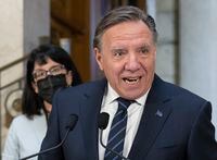 Quebec Premier Francois Legault reacts to the federal election, Tuesday, September 21, 2021 at the legislature in Quebec City. Quebec Minister Responsible for Canadian Relations and the Canadian Francophonie Sonia Lebel, left, looks on. THE CANADIAN PRESS/Jacques Boissinot
