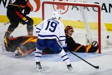 Toronto Maple Leafs forward Calle Jarnkrok, left, scores on Calgary Flames goalie Jacob Markstrom during third period NHL hockey action in Calgary, Thursday, March 2, 2023.THE CANADIAN PRESS/Jeff McIntosh