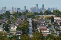 Single-family homes are seen against the skyline of Vancouver, on Sept. 30, 2020.