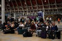 Passengers wait for trains at Paddington railway station, in London, during a railway workers strike, Thursday, June 23, 2022. Millions of people in Britain faced disruption Thursday as railway staff staged their second national walkout this week. (AP Photo/Matt Dunham)