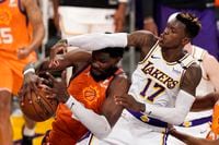 Phoenix Suns center Deandre Ayton, left, grabs a rebound away from Los Angeles Lakers guard Dennis Schroder during the second half in Game 4 of an NBA basketball first-round playoff series Sunday, May 30, 2021, in Los Angeles. (AP Photo/Mark J. Terrill)