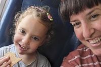 This undated family photo provided by Rachel Gur shows Yahel Shoham, 3, and her mother, Adi Shoham. They are believed to be hostages in Gaza in the wake of the Hamas attack on Kibbutz Be'eri, along with other family members. (Rachel Gur via AP)