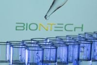 FILE PHOTO: Test tubes are seen in front of a displayed Biontech logo in this illustration taken, May 21, 2021. REUTERS/Dado Ruvic/Illustration/File Photo