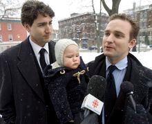 Alexandre "Sasha" Trudeau holds his son Pierre, while speaking to reporters as his brother Justin looks on before a memorial service for former Senator Jacques Hebert in Montreal, Friday, Dec. 14, 2007.  THE CANADIAN PRESS/Ryan Remiorz