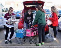McMaster University students (l. to r.) Mila Stankovic , Cassandra Faber, Sophia Voutranicis,  and Alicia Lake  move belongings from residence. McMaster University requested all students living on campus move out as more coronavirus cases appear in Hamilton and across the country.