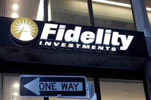 In this Oct. 14, 2019 file photo a Fidelity Investments logo is attached to a building, in Boston. Fidelity is launching a new type of account for teenagers to save, spend and invest their money. The account is for 13- to 17-year-olds, and it will allow them to deposit cash, have a debit card and trade stocks and funds. (AP Photo/Steven Senne, File)