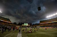 A storm covers the sky as the Calgary Stampeders take on the Edmonton Elks during second half CFL action in Edmonton, Alta., on Thursday July 7, 2022. THE CANADIAN PRESS/Jason Franson.