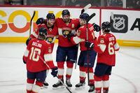 Teammates celebrate with Florida Panthers defenseman Aaron Ekblad (5) after he scored during the second period of an NHL hockey game against the Montreal Canadiens, Thursday, March 16, 2023, in Sunrise, Fla. (AP Photo/Rebecca Blackwell)