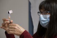 Heather Witzel-Garnhum, nurse clinician, prepares a syringe with the Pfizer-BioNTech COVID-19 vaccine at the Regina General Hospital on Tuesday Dec. 15, 2020. THE CANADIAN PRESS/Michael Bell