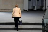 FILE - German Chancellor Angela Merkel leaves the plenary hall after a debate about the situation in Germany ahead of national elections in Berlin, Sept. 7, 2021. Merkel has been credited with raising Germany’s profile and influence, helping hold a fractious European Union together, managing a string of crises and being a role model for women in a near-record tenure. Her designated successor, Olaf Scholz, is expected to take office Wednesday, Dec. 8, 2021. (AP Photo/Markus Schreiber, File)