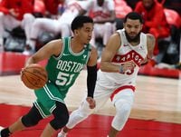 Jan 4, 2021; Tampa, Florida, USA; Boston Celtics guard Tremont Waters (51) drives to the basket as Toronto Raptors guard Fred VanVleet (23) defends during the second half at Amalie Arena. Mandatory Credit: Kim Klement-USA TODAY Sports