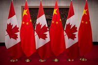 FILE PHOTO: Picture of Canadian and Chinese flags taken prior to the meeting with Canada's Prime Minister Justin Trudeau and China's President Xi Jinping at the Diaoyutai State Guesthouse on December 5, 2017, in Beijing. Fred Dufour/Pool via REUTERS/File Photo