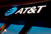 The AT&T logo is displayed at a store in Washington, DC, on January 18, 2022. - AT&T and Verizon agreed Tuesday to a partial delay in activating their 5G networks following an outcry from US airlines, who said the rollout could lead to travel chaos. (Photo by Stefani Reynolds / AFP) (Photo by STEFANI REYNOLDS/AFP via Getty Images)