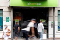 FILE PHOTO: People walk past a branch of Jobcentre Plus, a government run employment support and benefits agency, as the outbreak of the coronavirus disease (COVID-19) continues, in Hackney, London, Britain, August 6, 2020. REUTERS/John Sibley/File Photo/File Photo