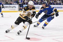 Apr 2, 2023; St. Louis, Missouri, USA; Boston Bruins right wing David Pastrnak (88) controls the puck from St. Louis Blues center Tyler Pitlick (9) during the first period at Enterprise Center. Mandatory Credit: Jeff Le-USA TODAY Sports