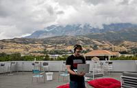 Lance Winward, an engineer at Qualtrics, a data analytics company, has a phone conference on the company’s patio in Provo, Utah, Sept. 15, 2017. Utah has a thriving technology hub dubbed “Silicon Slopes” in the roughly 80-mile swath dubbed from Provo to Ogden, with Salt Lake City in between. (Kim Raff/The New York Times)
