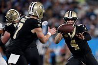 CHARLOTTE, NORTH CAROLINA - SEPTEMBER 18: Derek Carr #4 of the New Orleans Saints tosses the ball to Taysom Hill #7 against the Carolina Panthers during the fourth quarter in the game at Bank of America Stadium on September 18, 2023 in Charlotte, North Carolina. (Photo by Jared C. Tilton/Getty Images)