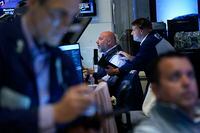 Traders work on the floor at the New York Stock Exchange in New York, Wednesday, July 27, 2022. (AP Photo/Seth Wenig)