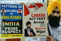 A member of a Sikh organisation holds a placard displaying Sikh separatist Hardeep Singh Nijjar in Amritsar on September 22, 2023. An activist for the creation of an independent Sikh homeland called Khalistan, Hardeep Singh Nijjar was wanted by Indian authorities for alleged terrorism and conspiracy to commit murder, and was shot dead by two masked assailants near Vancouver in June. (Photo by Narinder NANU / AFP) (Photo by NARINDER NANU/AFP via Getty Images)