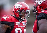 Calgary Stampeders' Kamar Jorden, left, celebrates his touchdown with a teammate during first quarter CFL football action against the Montreal Alouettes, in Calgary, Saturday, July 21, 2018. Jorden won't be hitting the CFL free-agent market. The Calgary Stampeders re-signed the all-star receiver to a two-year deal Friday. Jorden was eligible to become a free agent next month. THE CANADIAN PRESS/Jeff McIntosh