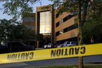 FILE - In this June 29, 2018, file photo, crime scene tape surrounds a building housing The Capital Gazette newspaper's offices, in Annapolis, Md. A judge is scheduled Wednesday, Oct. 2, 2019, to hear arguments from attorneys again on whether graphic video of a shooting at the Maryland newspaper can be used at the alleged gunman's trial. Judge Laura Ripken arranged to watch the newspaper's surveillance video after court on Tuesday in the case against Jarrod Ramos, who is charged with killing five people at the Capital Gazette. (AP Photo/Patrick Semansky, File)