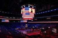 WASHINGTON, DC - JANUARY 11: The Phoenix Suns and Washington Wizards stand during the U.S. National Anthem at Capital One Arena on January 11, 2021 in Washington, DC. No fans were permitted due to safety concerns of the Covid-19 pandemic. NOTE TO USER: User expressly acknowledges and agrees that, by downloading and or using this photograph, User is consenting to the terms and conditions of the Getty Images License Agreement. (Photo by Patrick Smith/Getty Images)