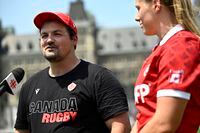 Canadian women's rugby coach Kevin Rouet participates in an interview as team captain Sophie de Goede listens, after a photo op with team captains on Parliament Hill in Ottawa, Wednesday, July 5, 2023. THE CANADIAN PRESS/Justin Tang