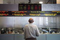 &nbsp;A man watches the financial numbers on the digital ticker tape at the TMX Group in Toronto's financial district on Friday, May 9, 2014. THE CANADIAN PRESS/Darren Calabrese