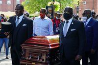 Pallbearers carry the casket of civil rights leader C.T. Vivian past Martin Luther King Jr. National Historic Park, in Atlanta, Ga., on July 22, 2020.